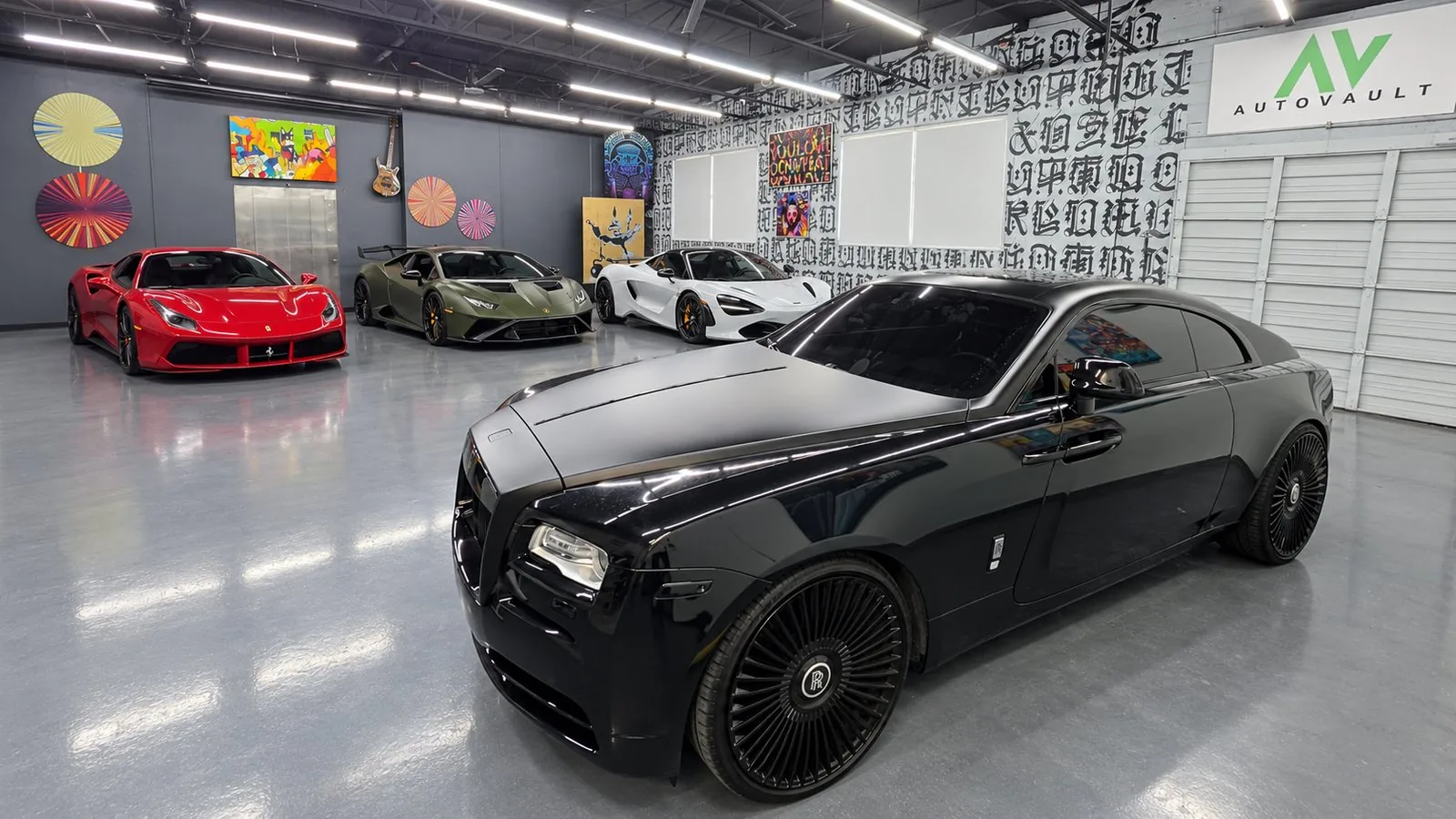 Exotic cars parked on the AutoVault showroom floor in North Miami under the AutoVault sign